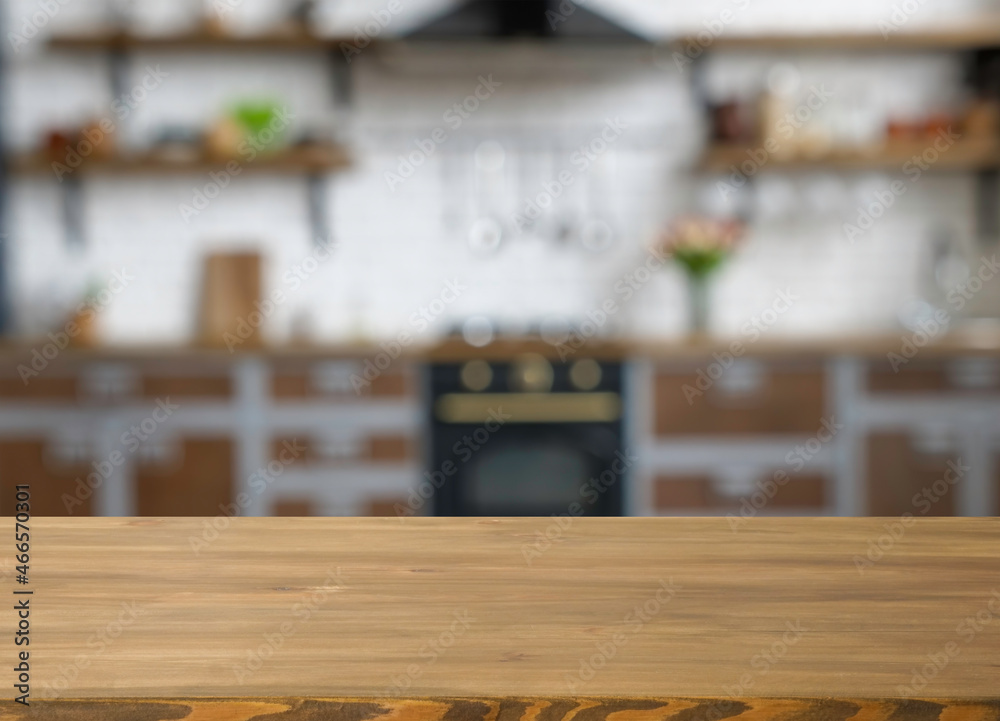 Wooden table with free space and blurred kitchen on the background. Wooden table with free space and blurred kitchen on the background.
