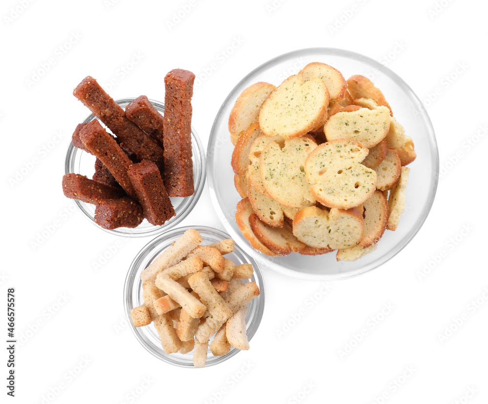 Different crispy rusks in bowls on white background, top view Different crispy rusks in bowls on white background, top view