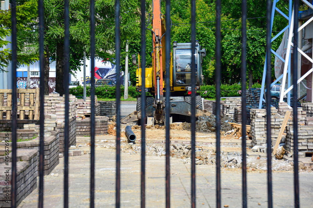 Construction site with appliances behind a fence. The concept of restrictions on construction objects.