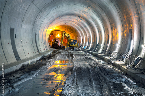 Excavator in construction place of building new railway tunnel. Railway corridor construction with machinery.