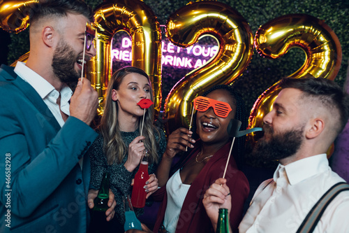 Happy group of friends celebrate New Year's Eve in a club