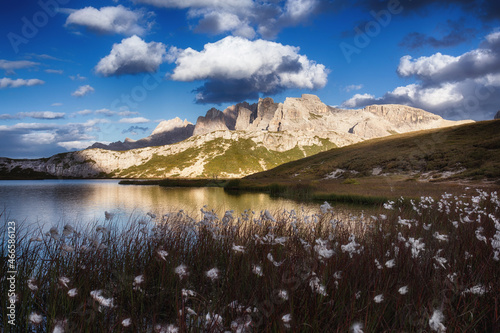 Obraz na płótnie Evening landscape with a lake against a background of mountains in the Dolomites, South Tyrol, Italy. Lago di Piani in the Tre Cime Nature Park, postcard view. Autumn landscape with mountain flowers. w salonie