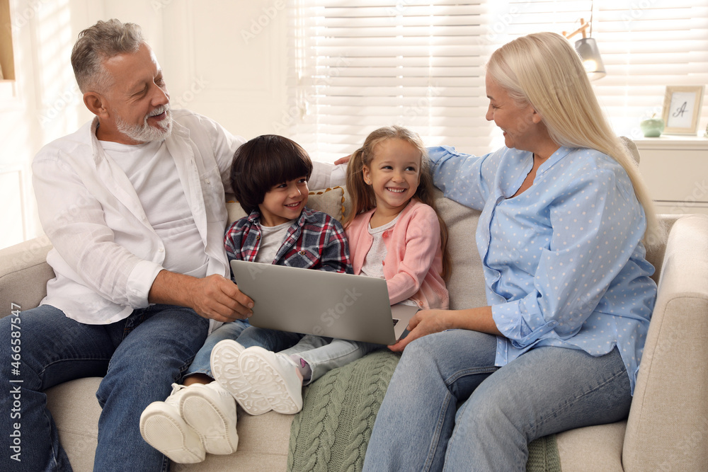 Happy grandparents spending time with grandchildren at home Happy grandparents spending time with grandchildren at home