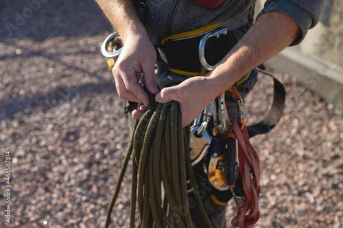 Skein of rope in the hands of an industrial climber. A man in the process of work