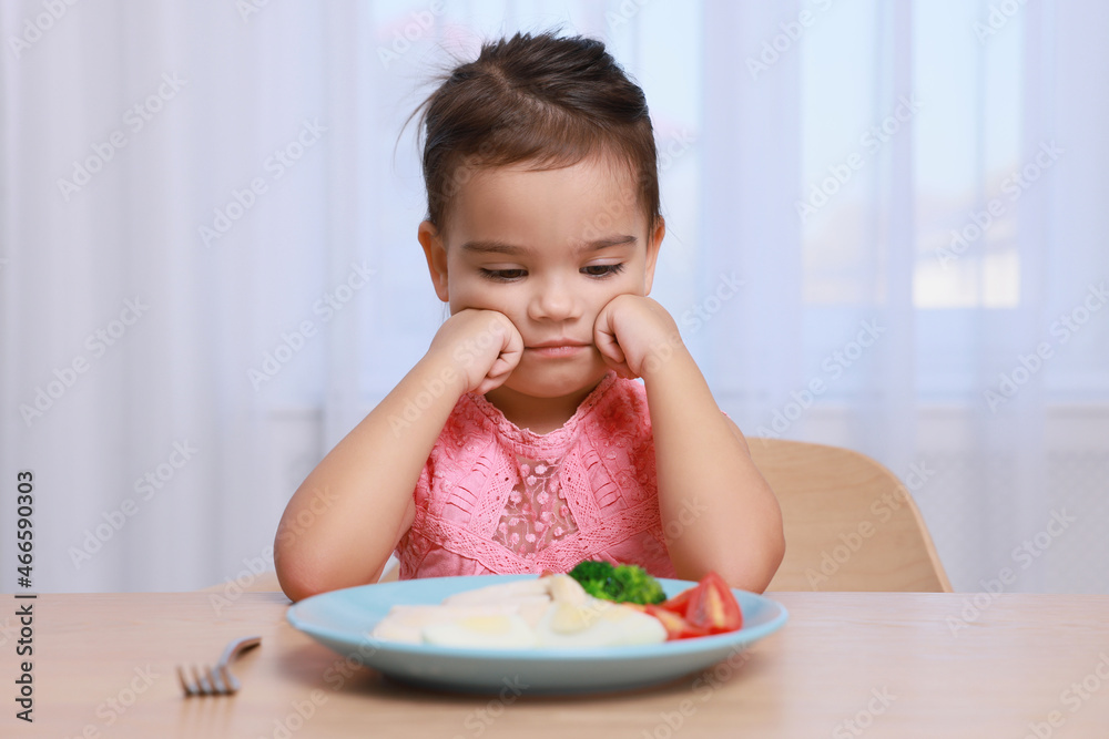 Cute little girl refusing to eat her breakfast at home Cute little girl refusing to eat her breakfast at home