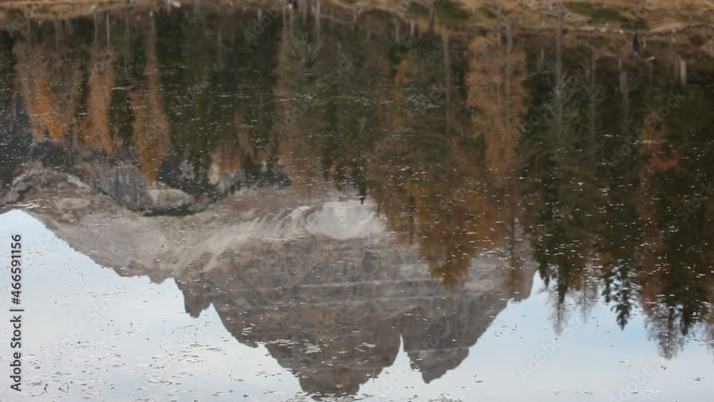 Tre Cime di Lavaredo peaks and autumn colored trees reflections in the Lake d'Antorno High quality FHD footage. Beautiful autumn scenery. Popular and famous travel destination Tre Cime di Lavaredo peaks and autumn colored trees reflections in the Lake d'Antorno High quality FHD footage. Beautiful autumn scenery. Popular and famous travel destination