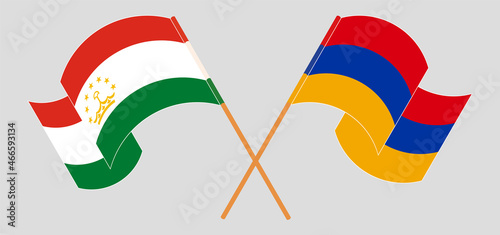 Crossed and waving flags of Tajikistan and Armenia.