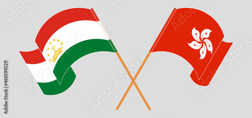 Crossed and waving flags of Tajikistan and Hong Kong