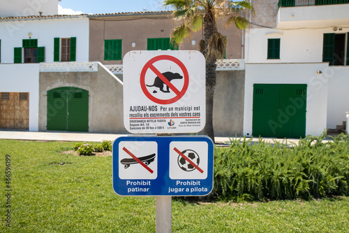 Majorca, Spain, 27th July 2021: A sign to warn about dogs fouling on the grass and to indicate no skateboarding or football games taken on the beautiful island of Majorca in Spain