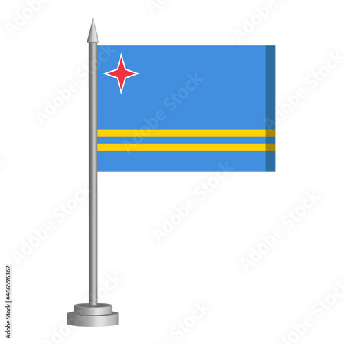 Flag of Aruba flying on a flagpole stands on the table