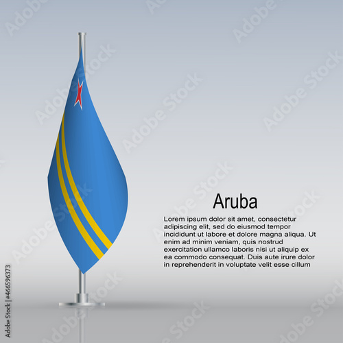 Flag of Aruba hanging on a flagpole stands on the table
