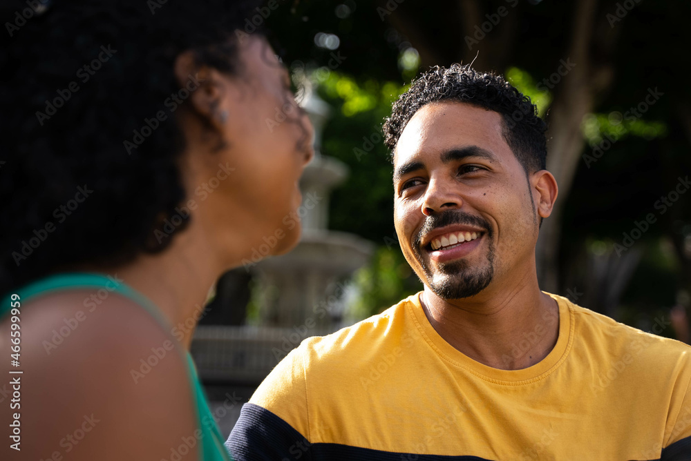 romantic african american couple sitting on a bench