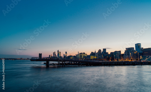 city skyline at sunrise bridge pier New York sky 