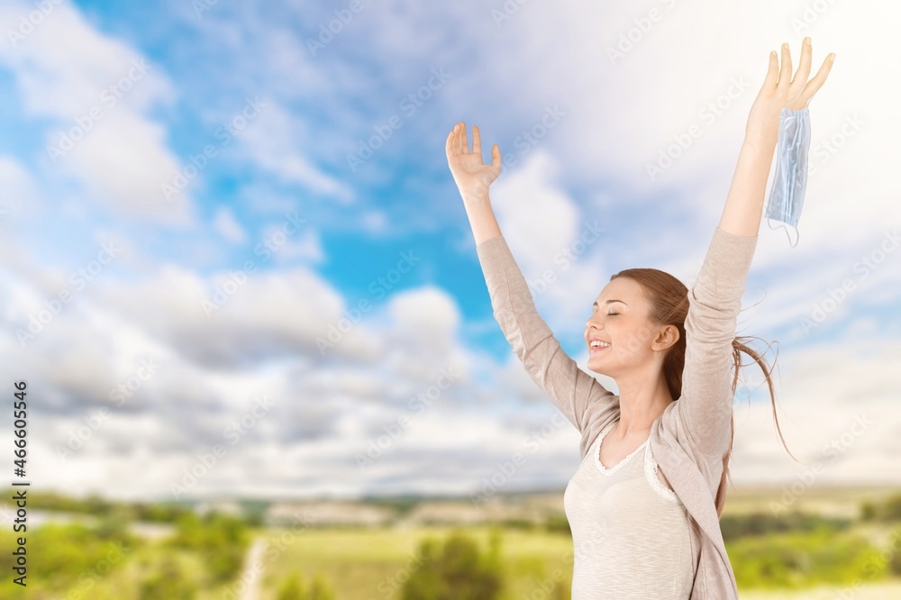 Woman with raising hands on the nature background Woman with raising hands on the nature background