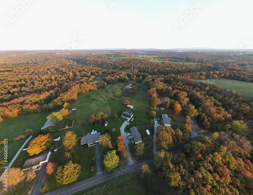 Early fall afternoon from the air overlooking rural neighborhood