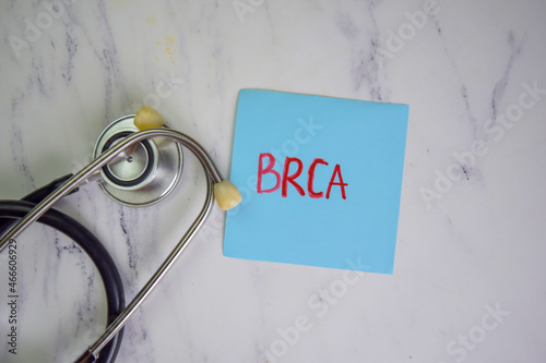 BRCA write on sticky notes isolated on Wooden Table. photo