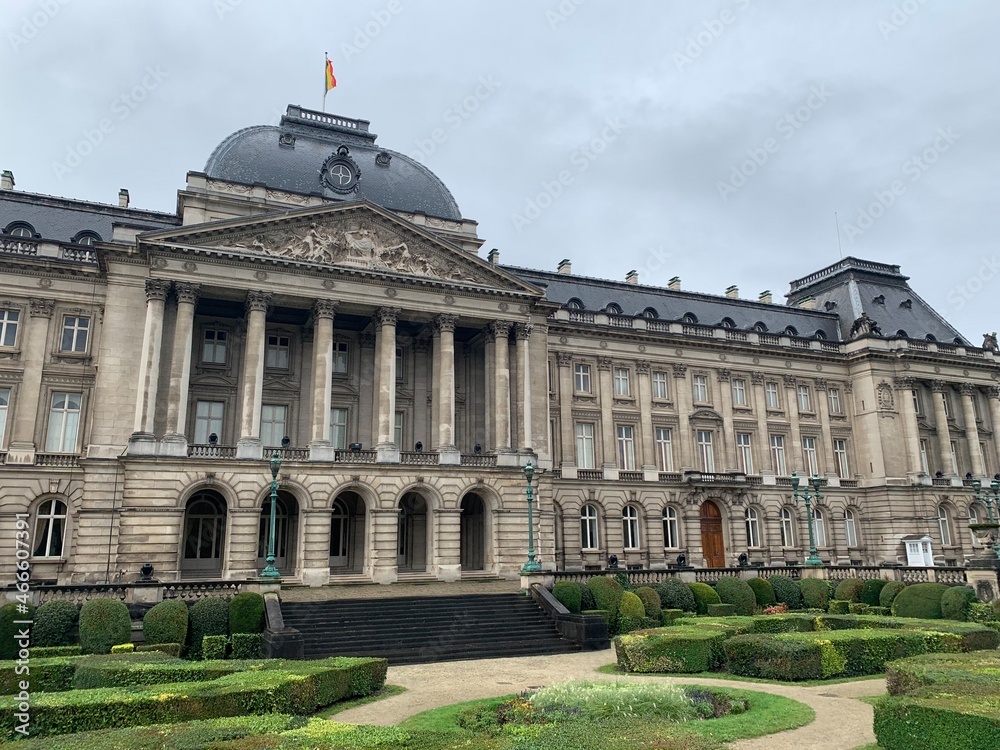 Front facade of The Royal Palace of Brussels. It is  is the official palace of the Belgian Royal family (King and Queen) in the city centre. Belgian flag on top of the building. Bruxelles, Belgium