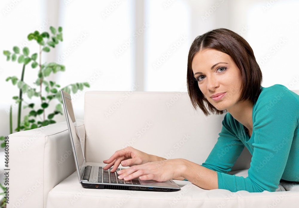 Positive smart young female freelancer or a student with laptop Positive smart young female freelancer or a student with laptop