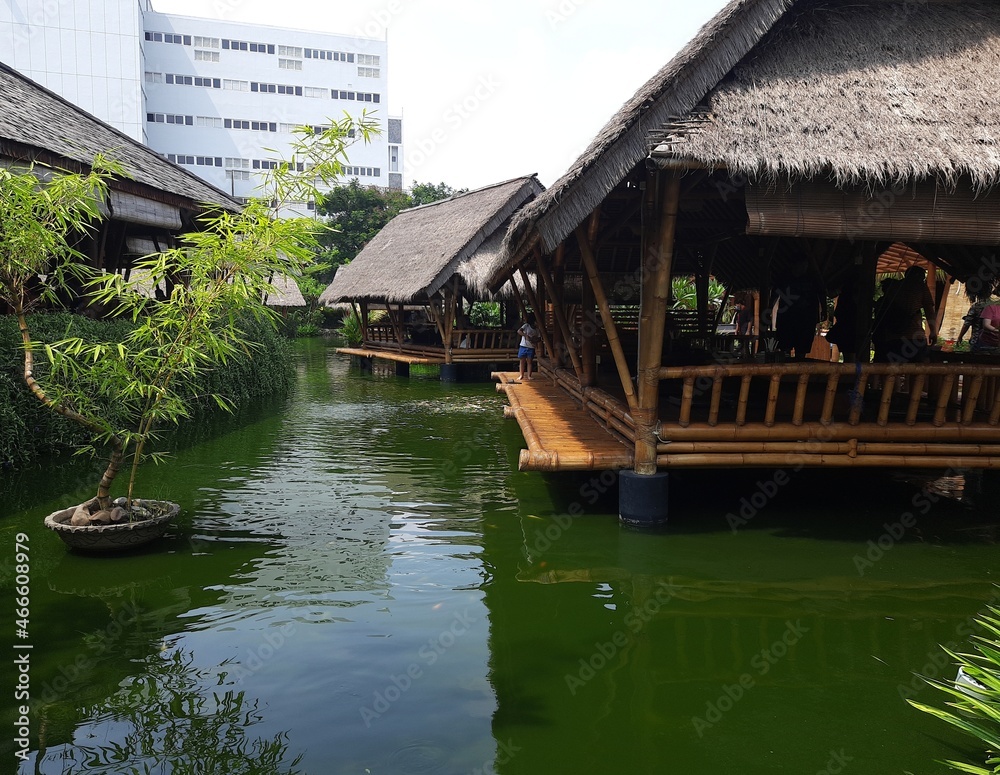 Traditional Asian wooden house on the lake. The floating village on the water Traditional Asian wooden house on the lake. The floating village on the water