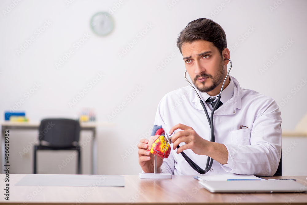 Young male doctor cardiologist working in the clinic Young male doctor cardiologist working in the clinic