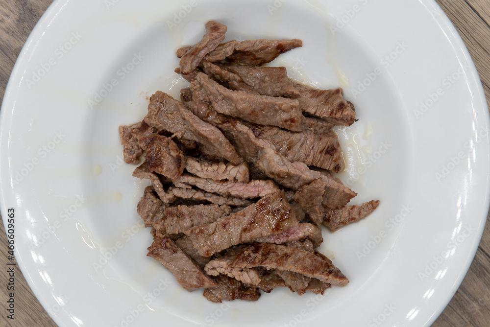 Overhead view of grilled and sliced Tikka steak served up in a bowl a la carte for some extra protein Overhead view of grilled and sliced Tikka steak served up in a bowl a la carte for some extra protein