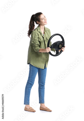 Young woman with steering wheel on white background © Pixel-Shot
