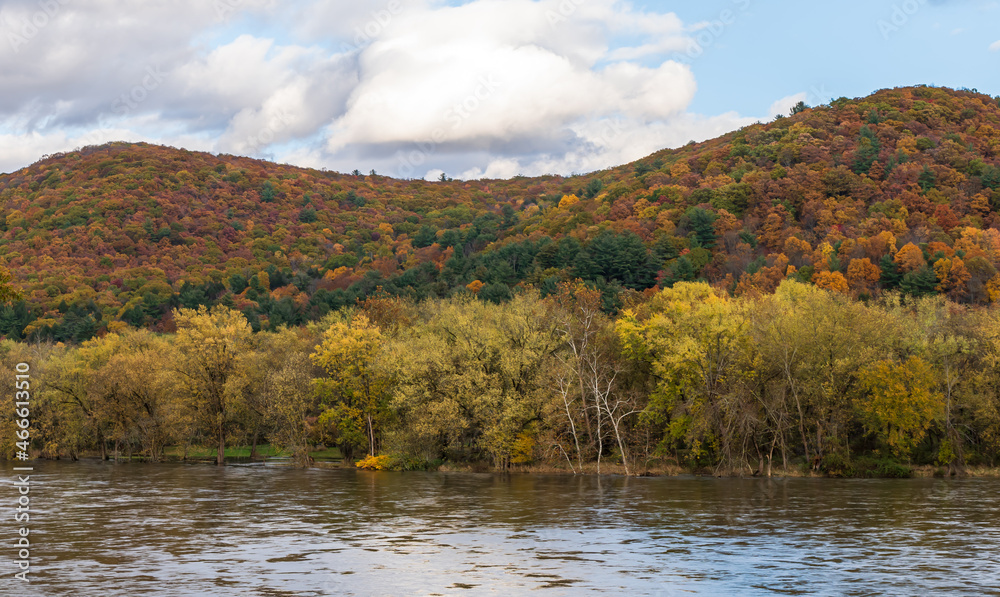 Colorful fall trees under sunny skies next to the Allegheny River in Althom, Pennsylvania, USA on an autumn day Colorful fall trees under sunny skies next to the Allegheny River in Althom, Pennsylvania, USA on an autumn day