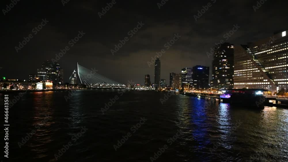 Rottedam, Holland. City of Rotterdam by night. Panoramic view of skyscrapers and lights on buildings in town. Night skyline in Rotterdam, Netherlands. Rottedam, Holland. City of Rotterdam by night. Panoramic view of skyscrapers and lights on buildings in town. Night skyline in Rotterdam, Netherlands.