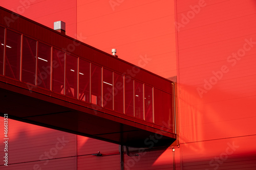 Closeup of a modern skyway connecting to a red building. photo