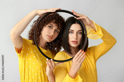 Young sisters holding round...