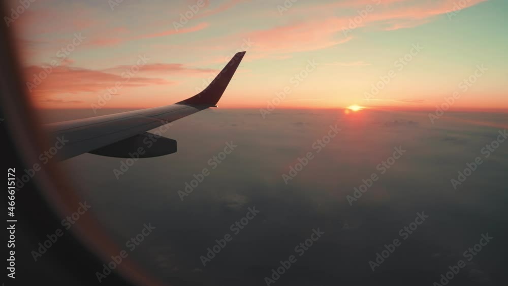 Passenger window view of commercial aircraft at sunset Passenger window view of commercial aircraft at sunset