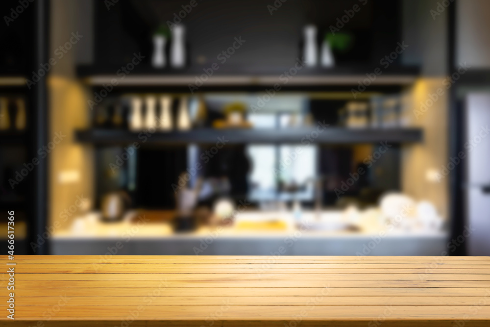 Wooden shelf with knife and blurred modern kitchen background cooking food. Stylish kitchen interior design.