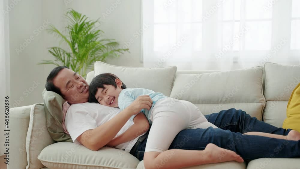 Asian Family Relations , Boy hugging his father and sleeping on the sofa
Asian Family Relations , Boy hugging his father and sleeping on the sofa