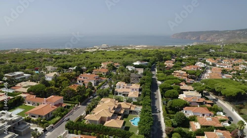 Aerial view over a rich neighborhood, in Quinta da Marinha, Lisbon - circling, drone shot photo
