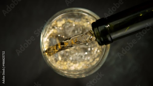 Super slow motion of pouring white wine into glass. Filmed on high speed cinema camera, 1000 fps photo