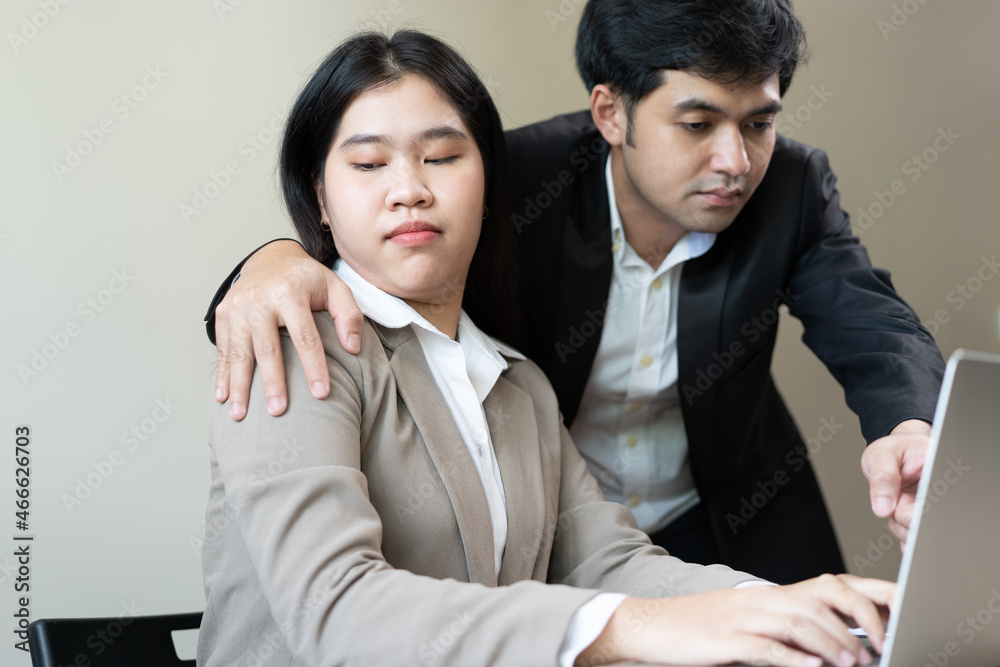 Unhappy asian young woman employee, man employer, colleague or boss touching at her shoulder feeling disgusted, uncomfortable. Sexual harassment inappropriate of business people at office, workplace. Unhappy asian young woman employee, man employer, colleague or boss touching at her shoulder feeling disgusted, uncomfortable. Sexual harassment inappropriate of business people at office, workplace.