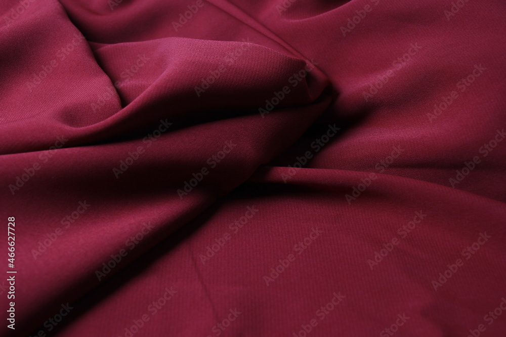 The texture of silk fabric burgundy color. Background, pattern. Luxury chiffon textile pattern. Luxurious valentines day background design The texture of silk fabric burgundy color. Background, pattern. Luxury chiffon textile pattern. Luxurious valentines day background design