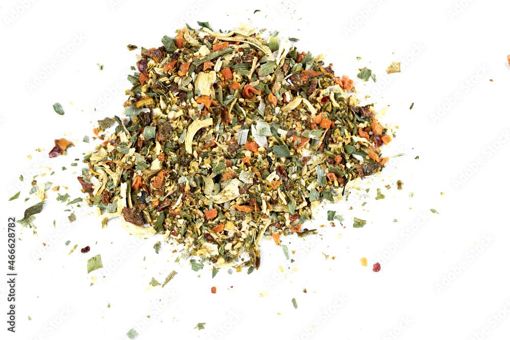 A mixture of seasonings scattered on a white background A mixture of seasonings scattered on a white background