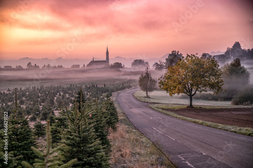 beautiful sunrise over a swiss village and the church 