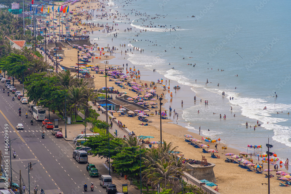 Panoramic coastal Vung Tau view from above, with waves, coastline, streets, coconut trees and Tao Phung mountain in Vietnam.