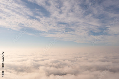 Aerial view white clouds in blue sky. View from drone. Aerial top view cloudscape. Texture of clouds. View from above. Panorama sky