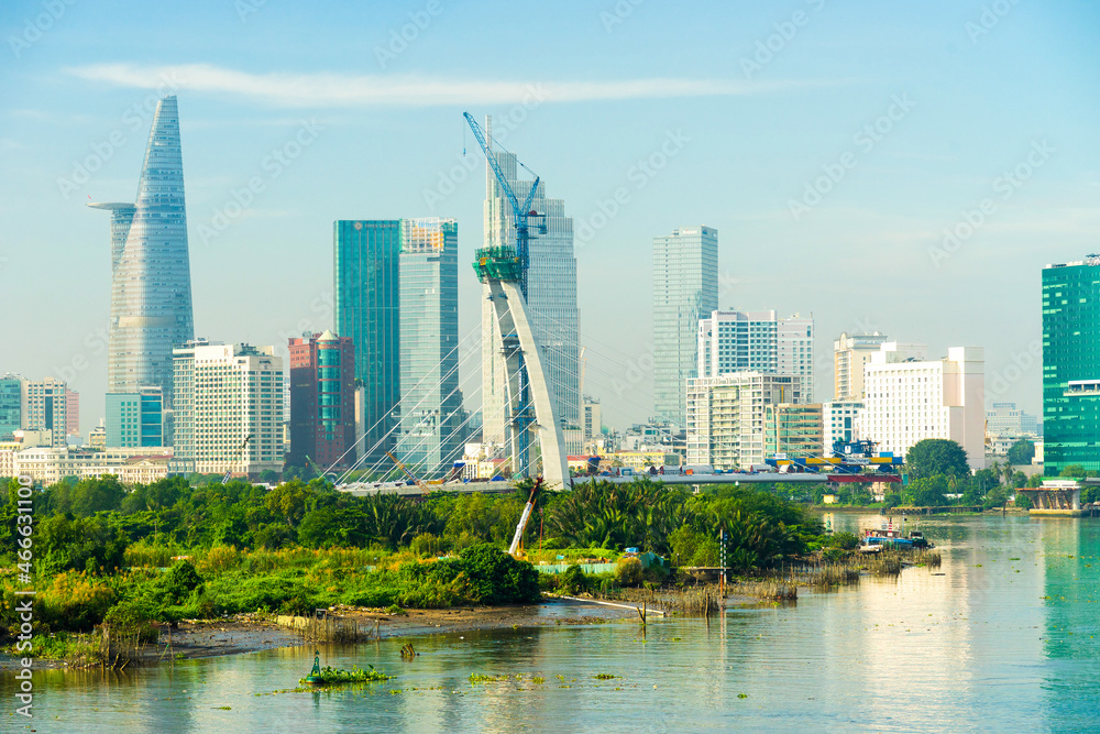 Aerial view of center Ho Chi Minh City, Vietnam with Bitexco Financial tower, Thu Thiem 2 bridge, buildings, energy power infrastructure. View from the Saigon river.