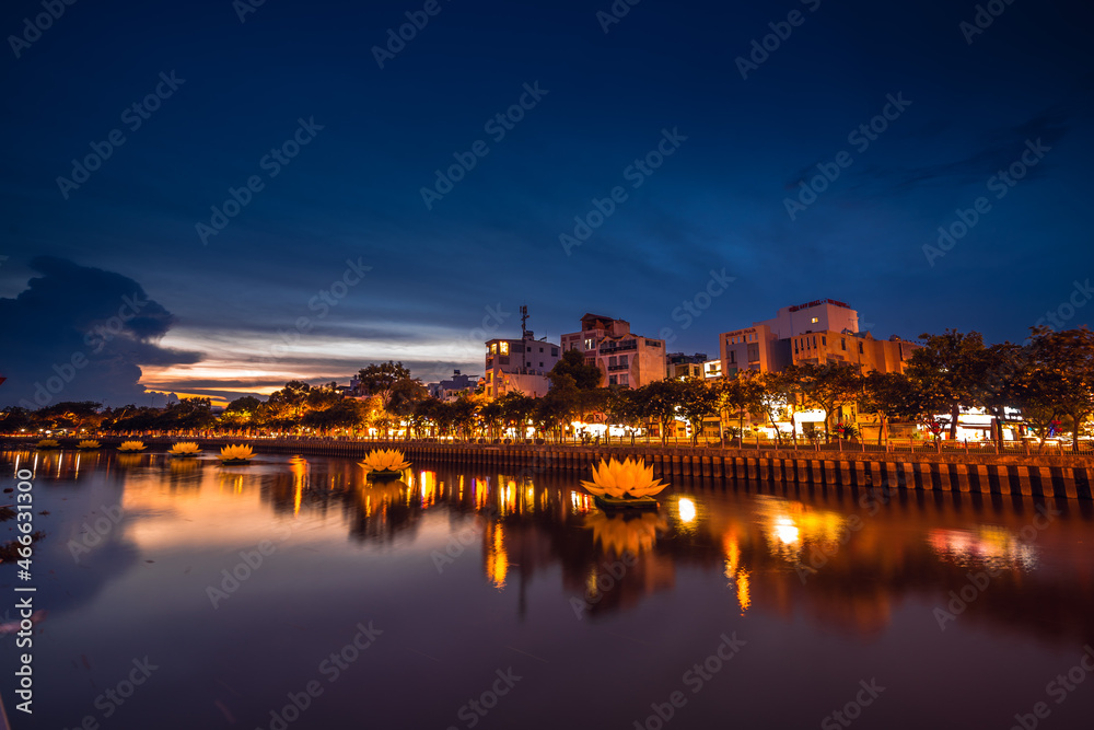 Floating colored lotus lanterns on river at night on Vesak day for celebrating Buddha's birthday in Eastern culture