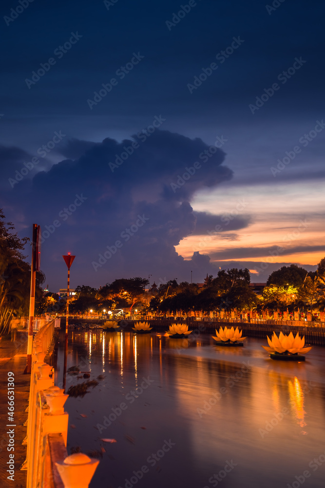 Floating colored lotus lanterns on river at night on Vesak day for celebrating Buddha's birthday in Eastern culture