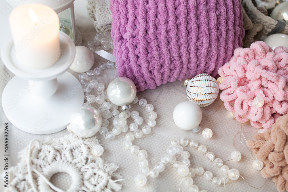 Beautiful delicate white christmas background with beads, balls, new year decor, knitted plush yarn pillow