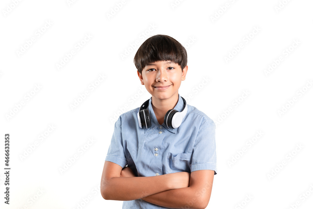 A smiling smart boy wearing headphones on his neck standing with his arms crossed looks at the camera, Music Education studies online, and homeschooling concept ideas. Isolated Over white background A smiling smart boy wearing headphones on his neck standing with his arms crossed looks at the camera, Music Education studies online, and homeschooling concept ideas. Isolated Over white background