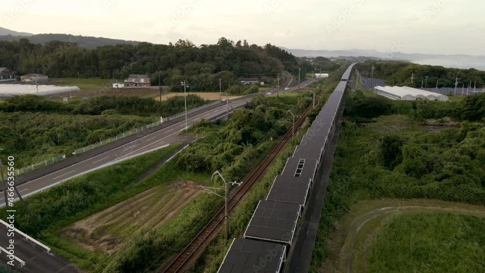 Solar Panels On An Abandoned Monorail Track In Japan With Passing Train Solar Panels On An Abandoned Monorail Track In Japan With Passing Train
