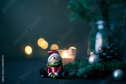 happy snowman and fir branches on the table. Christmas eve background with copy space. © Amore al Arte