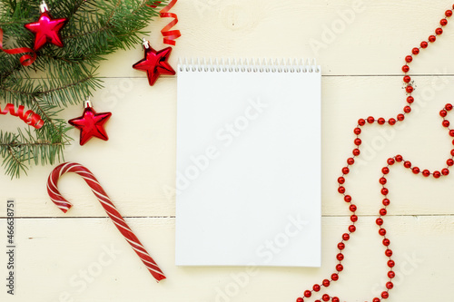 Banner. Happy New Year and Merry Christmas. fir twigs with red balls in the form of stars on a white wooden background. New Year background, top view, whiteboards