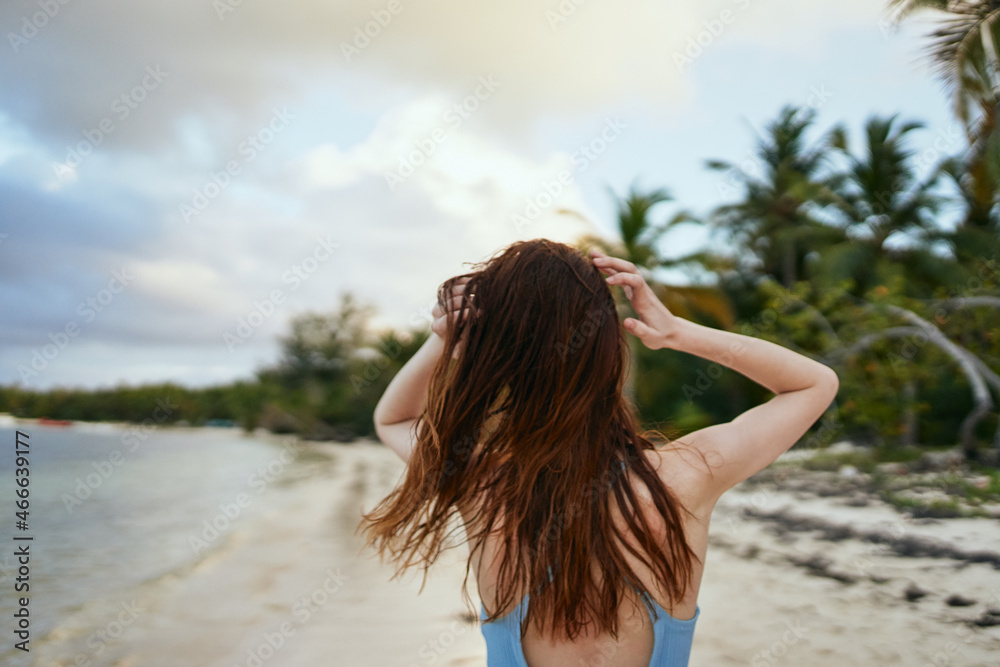 Naklejka premium woman in blue swimsuit on the beach island lifestyle